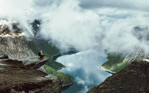 A man sits at the edge of Trolltunga from Chrome web store to be run with OffiDocs Chromium online A man sits at the edge of Trolltunga from Chrome web store to be run with OffiDocs Chromium online