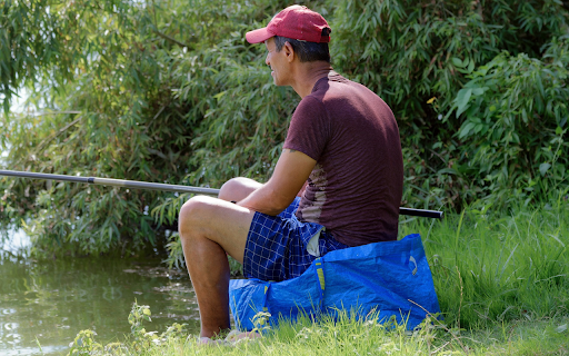 Man sitting in bushes fishing from Chrome web store to be run with OffiDocs Chromium online Man sitting in bushes fishing from Chrome web store to be run with OffiDocs Chromium online